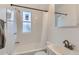 Bright bathroom featuring tiled walls, a bathtub, and vanity with sink at 1474 Clayton St, Denver, CO 80206