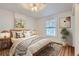 Bedroom featuring a cozy bed, stylish decor, and natural light from a window at 1474 Clayton St, Denver, CO 80206