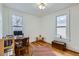 Bright room with hardwood floors, two windows, desk, and storage chest at 1474 Clayton St, Denver, CO 80206