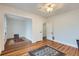 Bedroom with hardwood floors, white walls and trim, and a view to another room at 1474 Clayton St, Denver, CO 80206