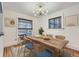 Bright dining room with a modern light fixture and view to outdoor patio at 1474 Clayton St, Denver, CO 80206