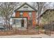 Charming brick two-story home featuring a well-manicured front yard and inviting entrance at 1474 Clayton St, Denver, CO 80206