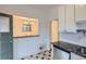 Kitchen with granite counters and view of dining area through pass-through at 1474 Clayton St, Denver, CO 80206