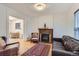 Bright living room featuring a fireplace, hardwood floors, and comfortable seating at 1474 Clayton St, Denver, CO 80206
