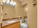 Bathroom with granite countertop, vanity, a mirror, and sconce lighting at 11768 Black Hawk Dr, Conifer, CO 80433