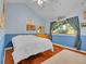 Bright bedroom with hardwood floors, a large bed, and plenty of natural light at 11768 Black Hawk Dr, Conifer, CO 80433
