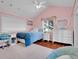 Pink bedroom featuring a cozy bed, white dresser, and lots of natural light at 11768 Black Hawk Dr, Conifer, CO 80433