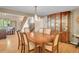 Formal dining room with a classic wooden table, elegant china cabinet, and ornate chandelier, perfect for gatherings at 11768 Black Hawk Dr, Conifer, CO 80433