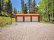 Spacious three-car garage provides ample storage and parking, complemented by a basketball hoop for recreation at 11768 Black Hawk Dr, Conifer, CO 80433