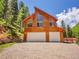 Two-car garage with high ceilings and a triangular window design offers ample space and natural light at 11768 Black Hawk Dr, Conifer, CO 80433