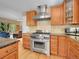 Gourmet kitchen with stainless steel appliances and custom cabinetry at 11768 Black Hawk Dr, Conifer, CO 80433