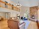 Open-concept living room boasts a stone fireplace, lofted ceilings, and comfortable seating, ideal for entertaining at 11768 Black Hawk Dr, Conifer, CO 80433