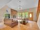 Bright living room features a stone fireplace, wood floors, and large windows offering scenic views at 11768 Black Hawk Dr, Conifer, CO 80433