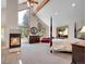 Large main bedroom featuring high ceilings, a fireplace, and views at 11768 Black Hawk Dr, Conifer, CO 80433