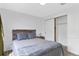 Bedroom with wood accent headboard, hardwood floors, and large closet at 4824 E Kentucky Ave # F, Denver, CO 80246