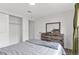 Bedroom with wood dresser and large mirror and hardwood flooring at 4824 E Kentucky Ave # F, Denver, CO 80246