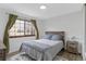 Bedroom with wood accent wall, hardwood flooring and natural light at 4824 E Kentucky Ave # F, Denver, CO 80246