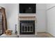 Fireplace featuring a flatscreen television, wood-look flooring, and firewood nearby at 4824 E Kentucky Ave # F, Denver, CO 80246