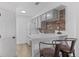 Open concept kitchen with breakfast bar, brick backsplash, and updated appliances at 4824 E Kentucky Ave # F, Denver, CO 80246