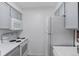 Kitchen with white appliances and white countertops with grey cabinets at 4824 E Kentucky Ave # F, Denver, CO 80246