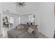 Bright open-concept living area with high ceilings and comfortable gray sectional sofa at 4824 E Kentucky Ave # F, Denver, CO 80246