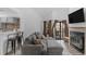 Living room with a comfortable gray sectional, fireplace, and eat-in kitchen at 4824 E Kentucky Ave # F, Denver, CO 80246