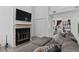 Living room with a tiled fireplace, flatscreen television, and access to a bonus room at 4824 E Kentucky Ave # F, Denver, CO 80246