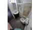 Bathroom with a shower over the bathtub, toilet, vinyl floor, and sink at 1272 N Ulster St, Denver, CO 80220