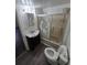 Bathroom with a shower over the bathtub, toilet, vinyl floor, and sink at 1272 N Ulster St, Denver, CO 80220