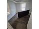 Small bedroom with carpet, two windows, and a bed leaning against the wall at 1272 N Ulster St, Denver, CO 80220