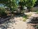 View of a driveway leading to the house, surrounded by trees and foliage at 1272 N Ulster St, Denver, CO 80220
