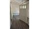 Covered porch entrance showing dark wood laminate flooring and white-painted walls and trim at 1272 N Ulster St, Denver, CO 80220