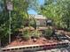 View of the front yard and exterior of the home, surrounded by trees and a chain-link fence at 1272 N Ulster St, Denver, CO 80220