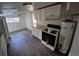 Compact kitchen featuring an oven, range, and plenty of cabinet space at 1272 N Ulster St, Denver, CO 80220