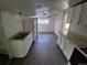 Kitchen with white cabinets, sink and appliances with vinyl flooring at 1272 N Ulster St, Denver, CO 80220