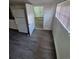 Kitchen with white cabinets, sink and appliances with vinyl flooring at 1272 N Ulster St, Denver, CO 80220