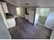 Kitchenette with laminate flooring, a refrigerator, sink, and multiple doorways at 1272 N Ulster St, Denver, CO 80220