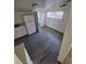 Kitchenette with laminate flooring, a refrigerator, sink, and access to a bathroom at 1272 N Ulster St, Denver, CO 80220
