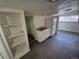 Kitchenette with laminate flooring, a refrigerator, sink, and open shelving at 1272 N Ulster St, Denver, CO 80220