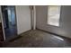 Neutral living room featuring carpet flooring and a window with blinds at 1272 N Ulster St, Denver, CO 80220