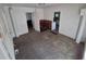 Open living room with an area of exposed brick and multiple doorways at 1272 N Ulster St, Denver, CO 80220