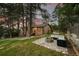 A charming single Gathering home featuring a stone patio with a fire pit and comfortable outdoor seating at 9416 Mcshane Ct, Parker, CO 80134