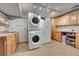 Functional laundry room with stacked washer/dryer, sink, and ample cabinet space at 9416 Mcshane Ct, Parker, CO 80134
