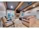 Comfortable living room with a brick fireplace and a skylight at 9416 Mcshane Ct, Parker, CO 80134