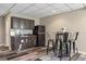 Kitchenette in basement with gray cabinets and black refrigerator at 22978 E Bailey Cir, Aurora, CO 80016