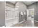 Accessible tile shower featuring a built-in seat and gray accent tile at 22978 E Bailey Cir, Aurora, CO 80016