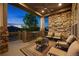 Inviting covered patio with stone features, comfortable seating, and serene outdoor living space at twilight at 22978 E Bailey Cir, Aurora, CO 80016