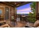 Relaxing covered patio with stone accents and comfortable seating offering a serene outdoor retreat at 22978 E Bailey Cir, Aurora, CO 80016