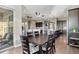 Open concept dining area with dark wood floors leading to a spacious kitchen and seating area with ample natural light at 22978 E Bailey Cir, Aurora, CO 80016