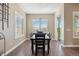 Bright dining room featuring modern lighting, wood floors, and shuttered windows for an elegant entertaining space at 22978 E Bailey Cir, Aurora, CO 80016